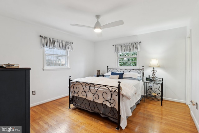 bedroom with ceiling fan and hardwood / wood-style floors