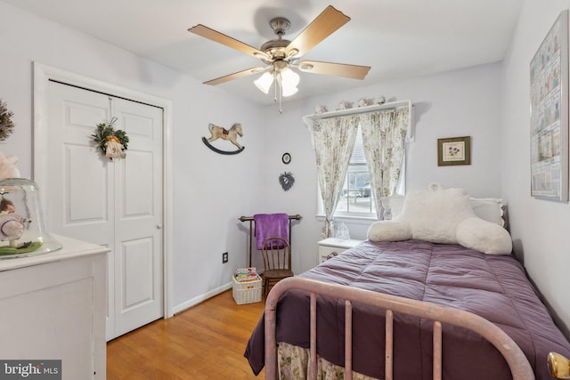 bedroom with ceiling fan, light wood-type flooring, and a closet