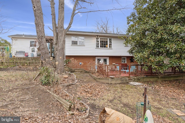 rear view of property with a deck and french doors