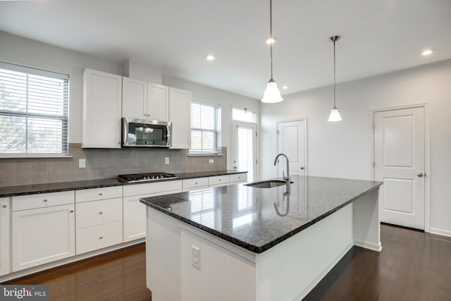 kitchen featuring sink, a center island with sink, white cabinets, and appliances with stainless steel finishes