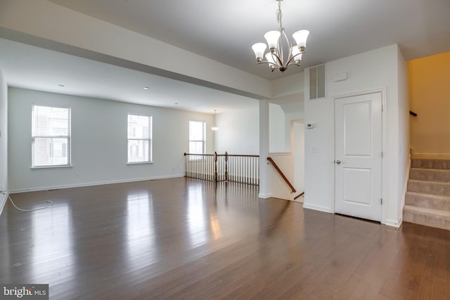 unfurnished room with dark hardwood / wood-style floors and a chandelier