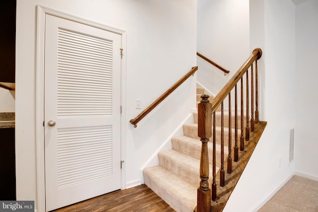 stairway with hardwood / wood-style flooring