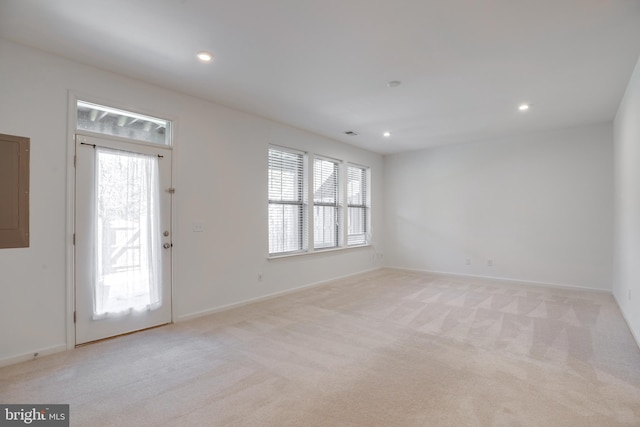 carpeted empty room with electric panel