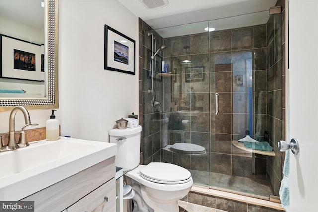 bathroom featuring walk in shower, vanity, and toilet