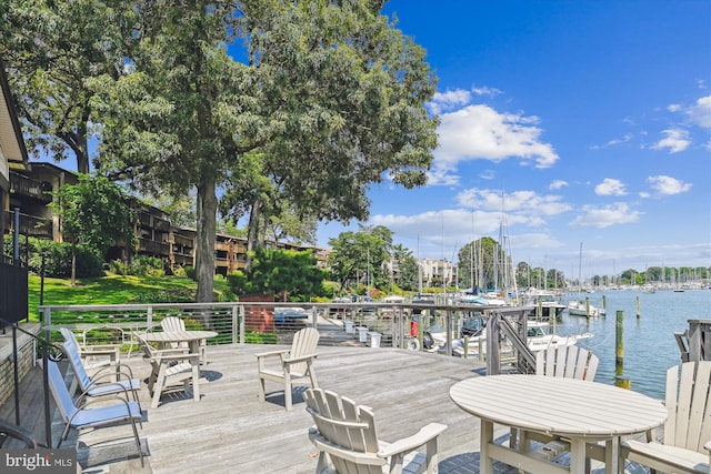 wooden deck featuring a water view and a boat dock