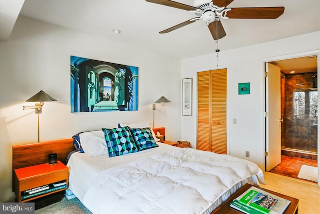 bedroom with ceiling fan, ensuite bath, carpet floors, and a closet