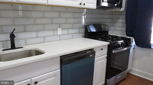 kitchen with tasteful backsplash, stainless steel appliances, sink, and white cabinets