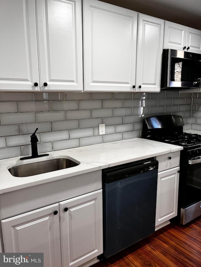 kitchen featuring tasteful backsplash, dishwasher, white cabinetry, sink, and gas range