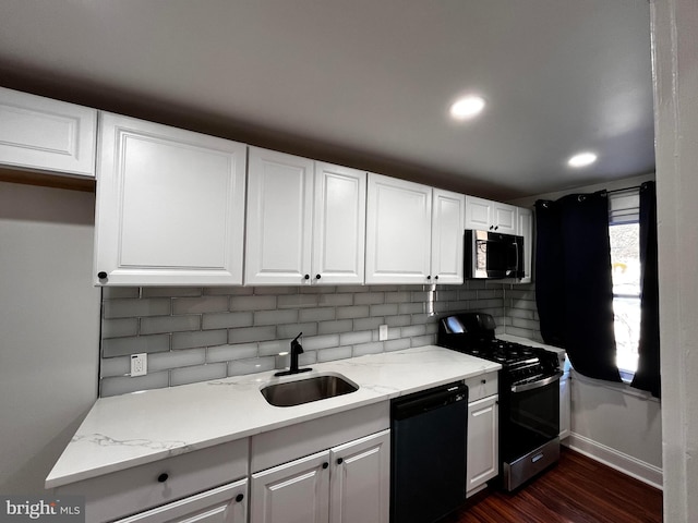 kitchen with sink, range with gas cooktop, white cabinets, and black dishwasher