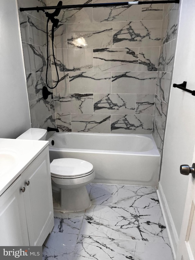 full bathroom with tiled shower / bath, vanity, and toilet