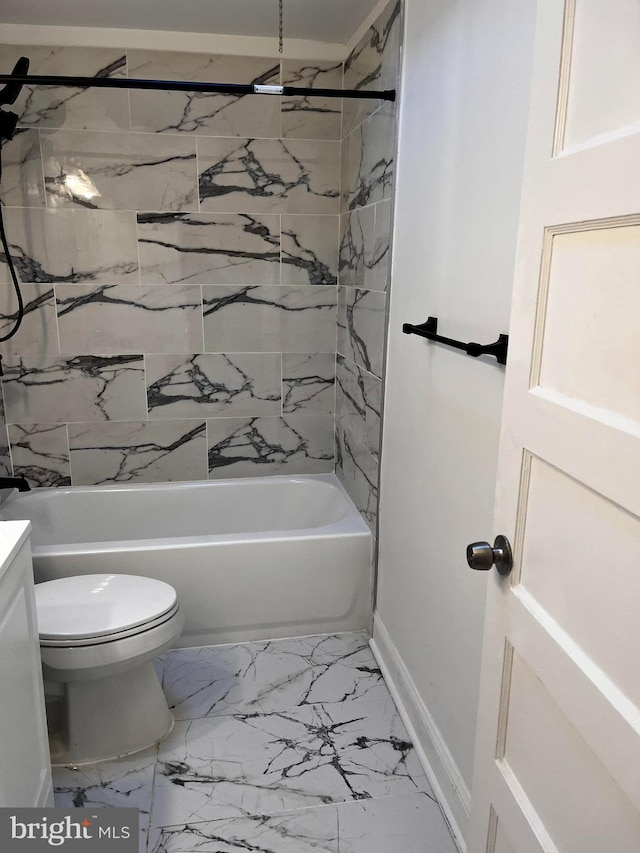 full bathroom featuring vanity, tiled shower / bath, and toilet