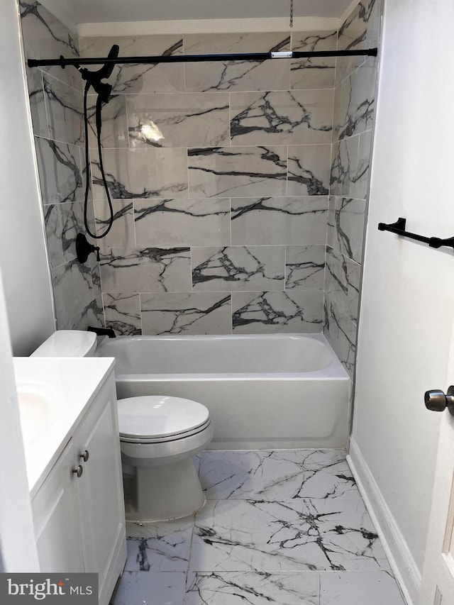 full bathroom featuring vanity, tiled shower / bath, and toilet