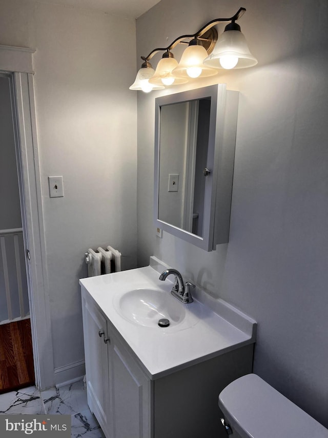 bathroom featuring vanity, radiator, and toilet