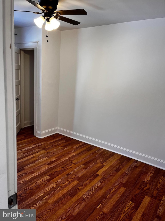 unfurnished room with dark hardwood / wood-style floors and ceiling fan