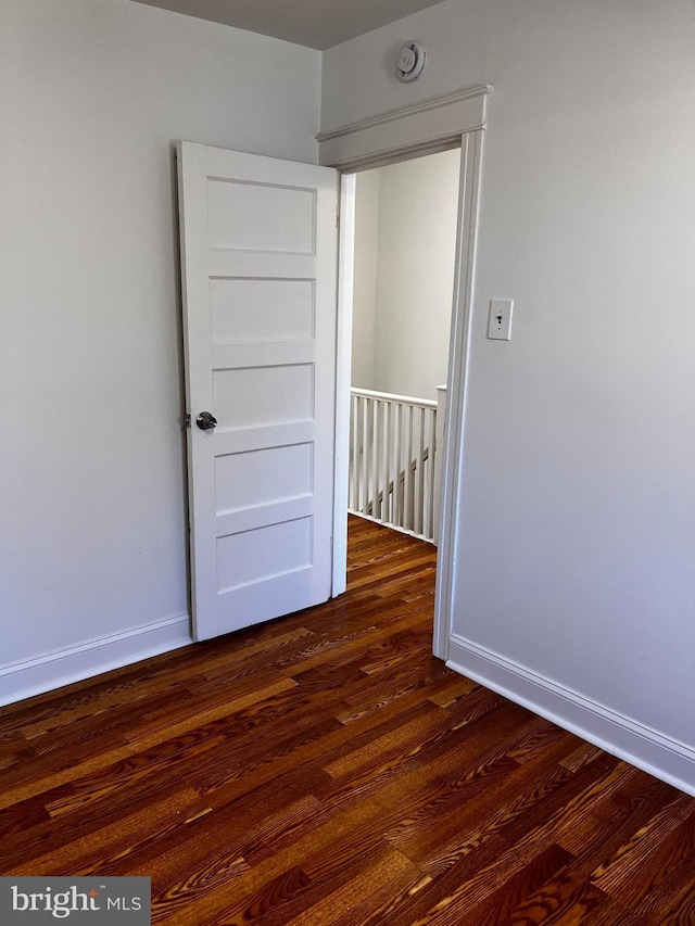 spare room with dark hardwood / wood-style floors