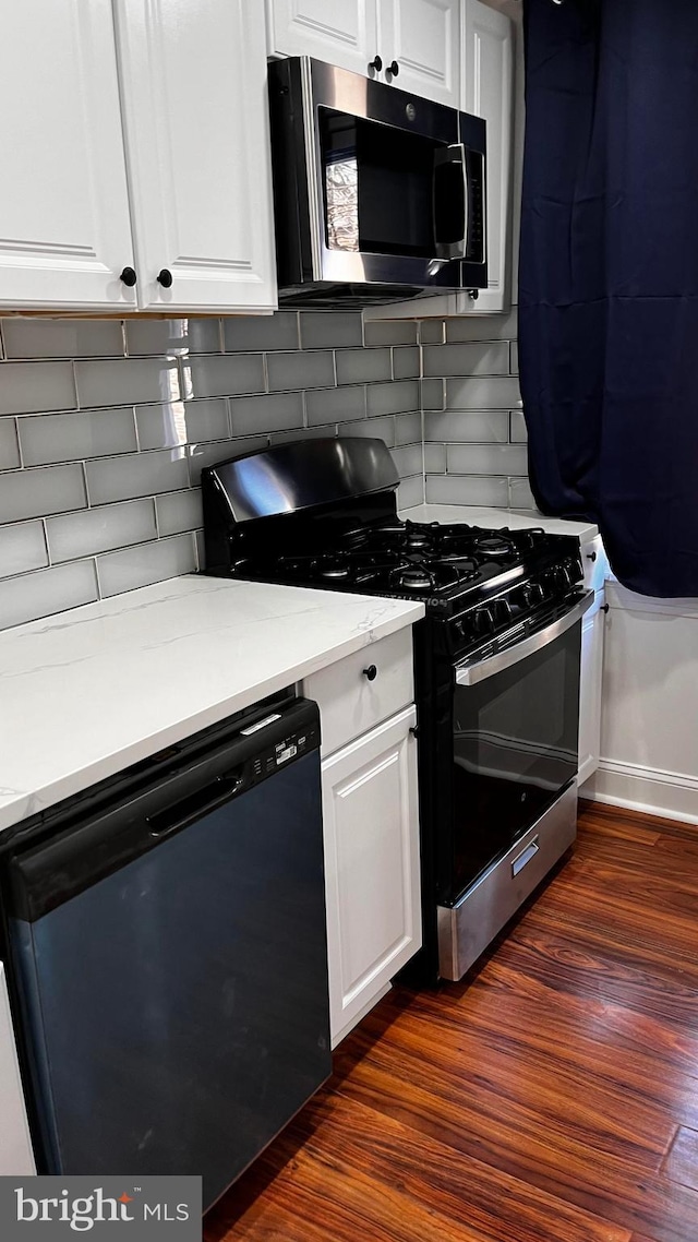 kitchen featuring white cabinetry, dark hardwood / wood-style flooring, gas stove, and black dishwasher