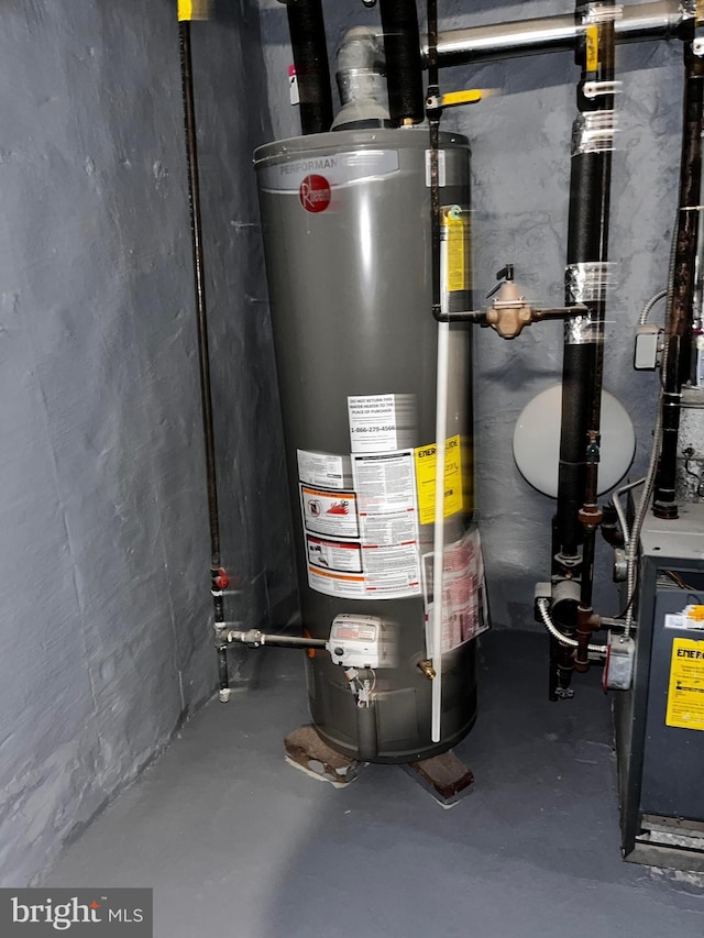 utility room featuring water heater