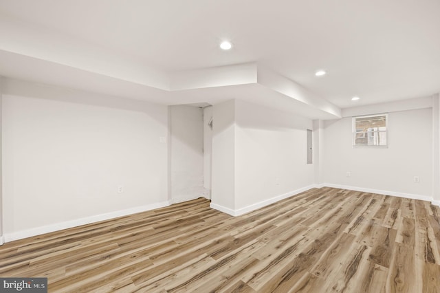 basement with light hardwood / wood-style flooring