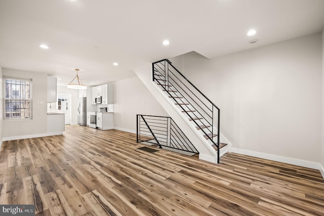 unfurnished living room featuring wood-type flooring