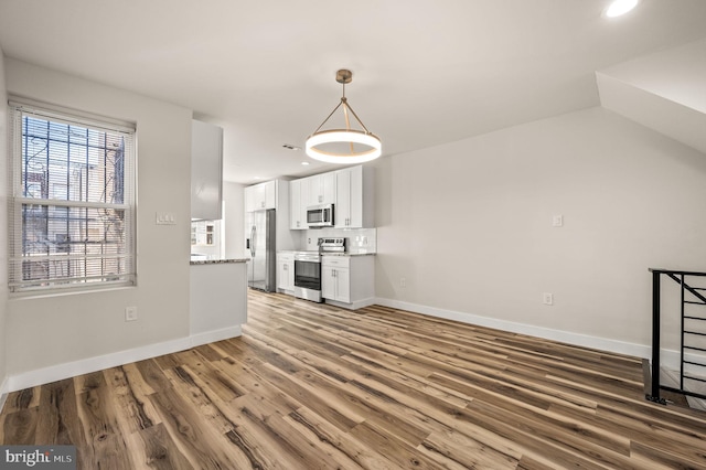 unfurnished living room with wood-type flooring