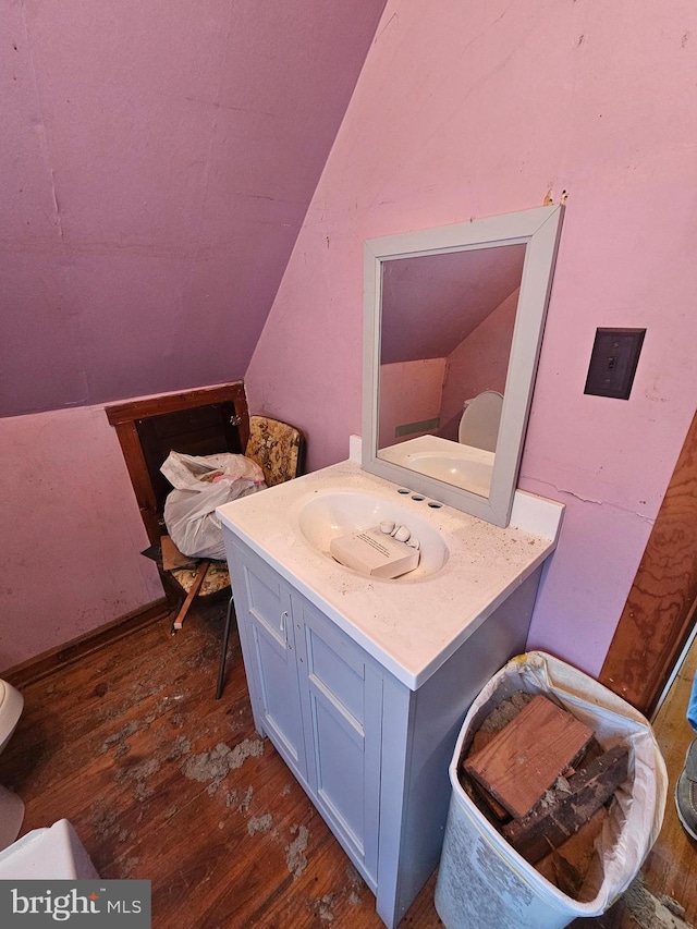 bathroom with wood-type flooring, toilet, and vanity