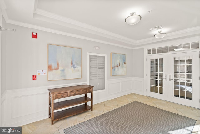 interior space with crown molding, a tray ceiling, tile patterned floors, and french doors