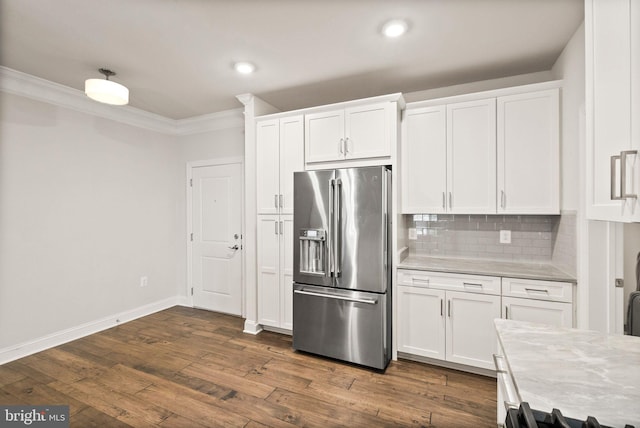 kitchen featuring tasteful backsplash, white cabinets, dark hardwood / wood-style flooring, crown molding, and high end fridge