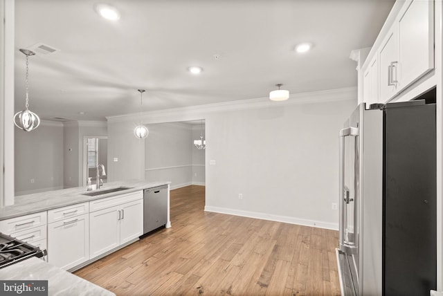 kitchen featuring white cabinetry, sink, hanging light fixtures, ornamental molding, and stainless steel appliances