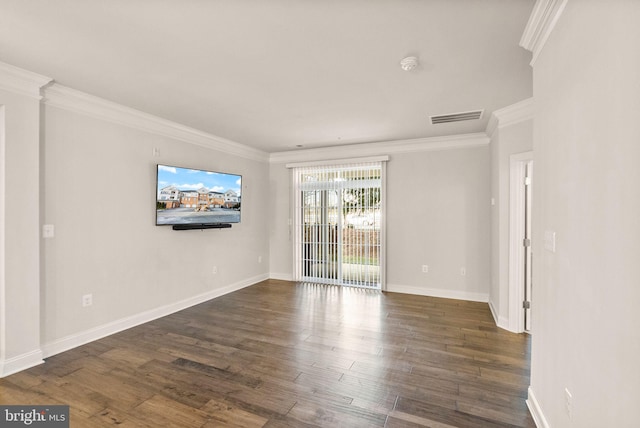 spare room featuring ornamental molding and dark hardwood / wood-style flooring