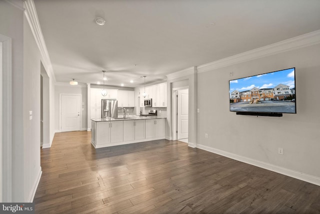 unfurnished living room with sink, crown molding, and dark wood-type flooring