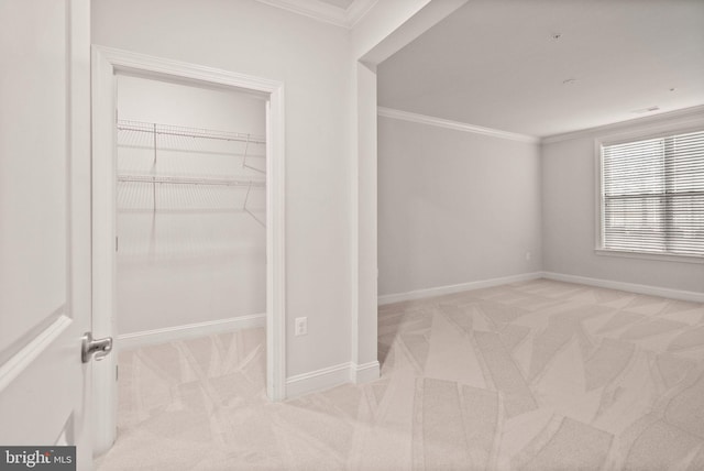 unfurnished bedroom with crown molding, a closet, and light carpet