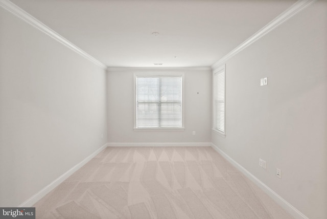 spare room with ornamental molding and light carpet