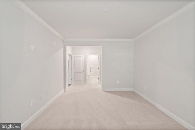 carpeted spare room with crown molding