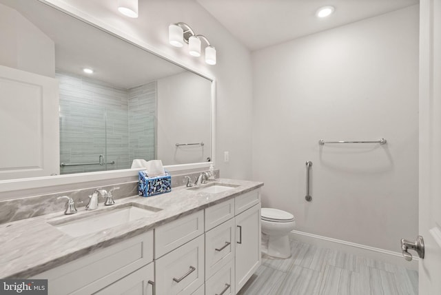 bathroom with an enclosed shower, vanity, and toilet