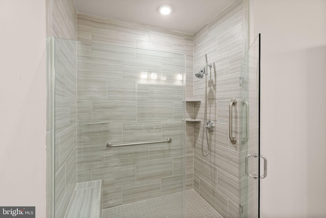 bathroom featuring a shower with shower door