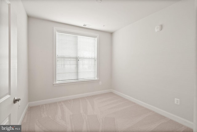 empty room with plenty of natural light and light carpet