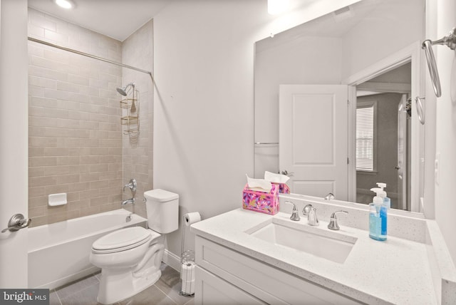 full bathroom featuring vanity, toilet, tiled shower / bath combo, and tile patterned flooring