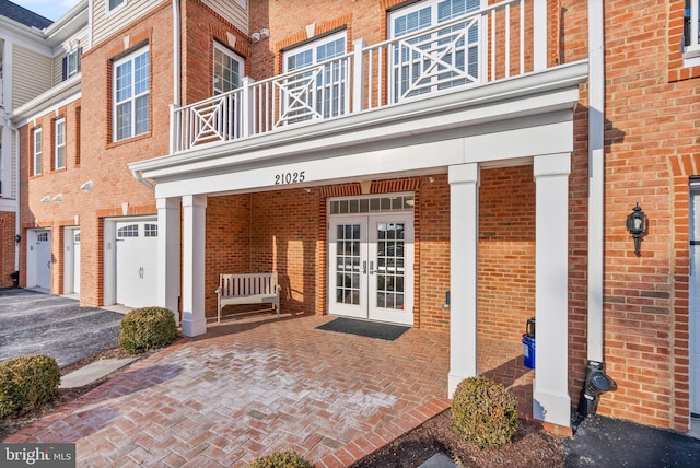 property entrance with a balcony and french doors