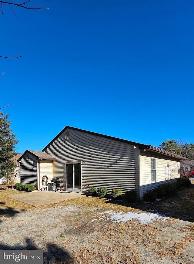 back of property featuring a patio area