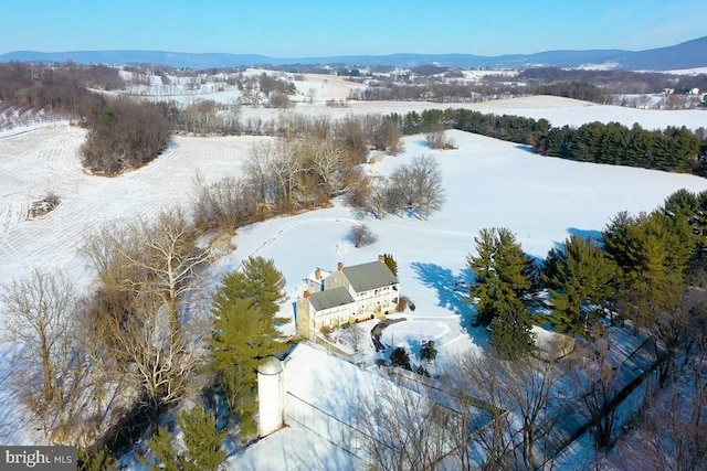 snowy aerial view featuring a mountain view