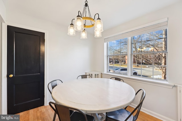 dining room with an inviting chandelier and light wood-type flooring