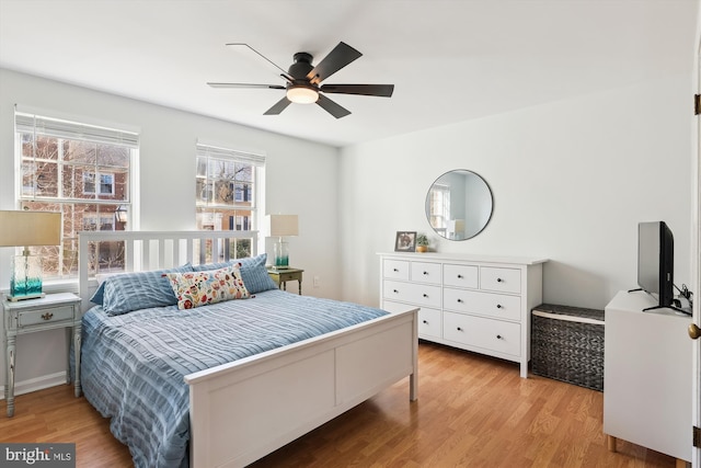 bedroom with light hardwood / wood-style floors and ceiling fan