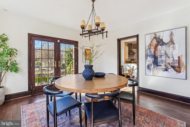 dining area featuring a notable chandelier, dark hardwood / wood-style floors, and french doors