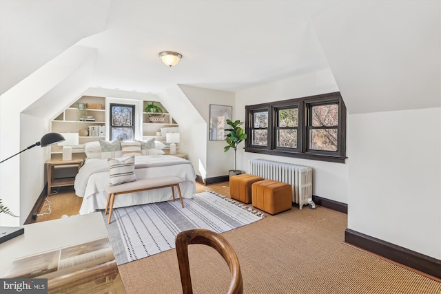 bedroom featuring radiator and vaulted ceiling