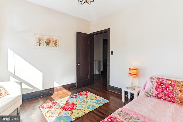 bedroom with dark hardwood / wood-style floors