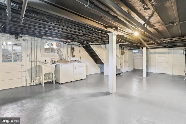 basement with separate washer and dryer and sink