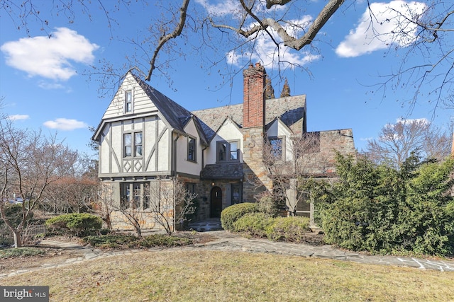 tudor home with a front yard