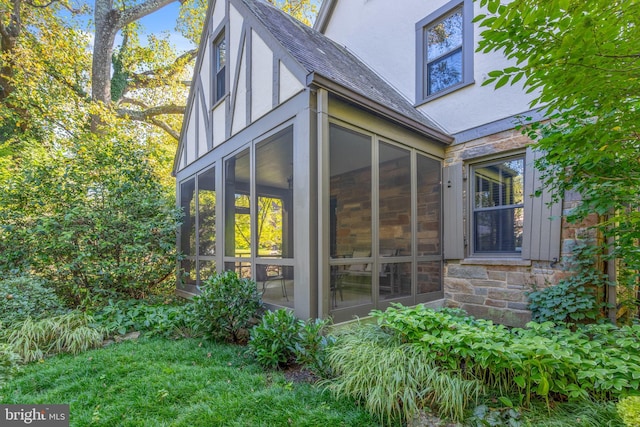 view of side of home with a sunroom