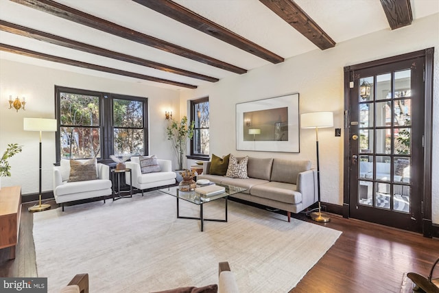 living room featuring dark hardwood / wood-style flooring and beamed ceiling