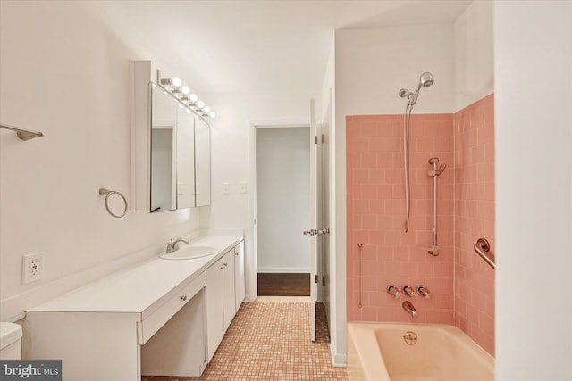 bathroom featuring washtub / shower combination, vanity, tile patterned flooring, and toilet